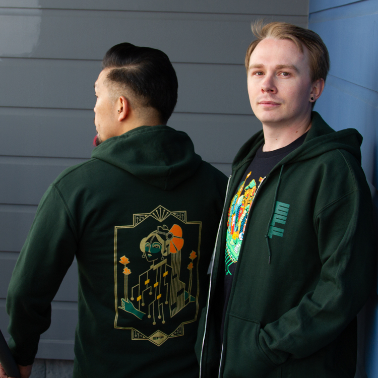 Get great EFF swag when you become a monthly Sustaining Donor. Person wearing a green hoodie with a gold motherboard figure and orange poppies on the back, next to a person wearing an EFF35 Cityscape member t-shirt.